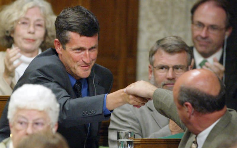 Svend Robinson, left, shakes hands with fellow MPs while he was serving in Parliament with the NDP in 2003. The former MP publicly admitted to stealing a valuable ring a year after this photo was taken. Photo from The Canadian Press.