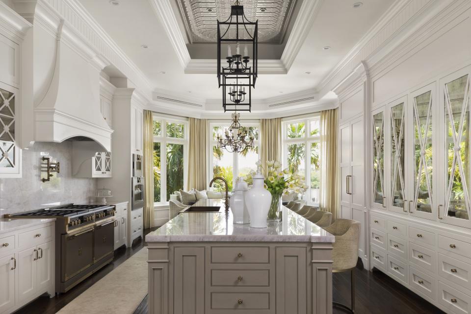 The kitchen has a plethora of cabinet space. One of the most unique items is the kitchen table that has a couch for seating on one side.