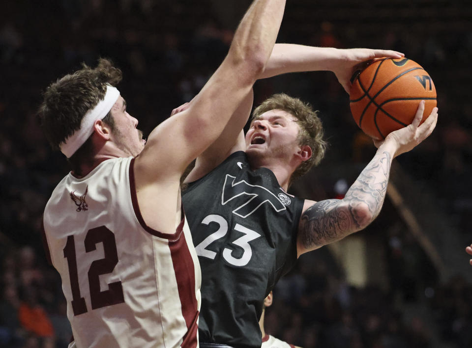 Boston College's Quinten Post (12) defends against Virginia Tech's Tyler Nickel (23) during the second half of an NCAA college basketball game Tuesday, Jan. 23, 2024, in Blacksburg, Va. (Matt Gentry/The Roanoke Times via AP)