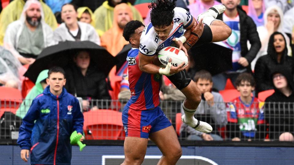 Dallin Watene-Zelezniak is tackled by Greg Marzhew.