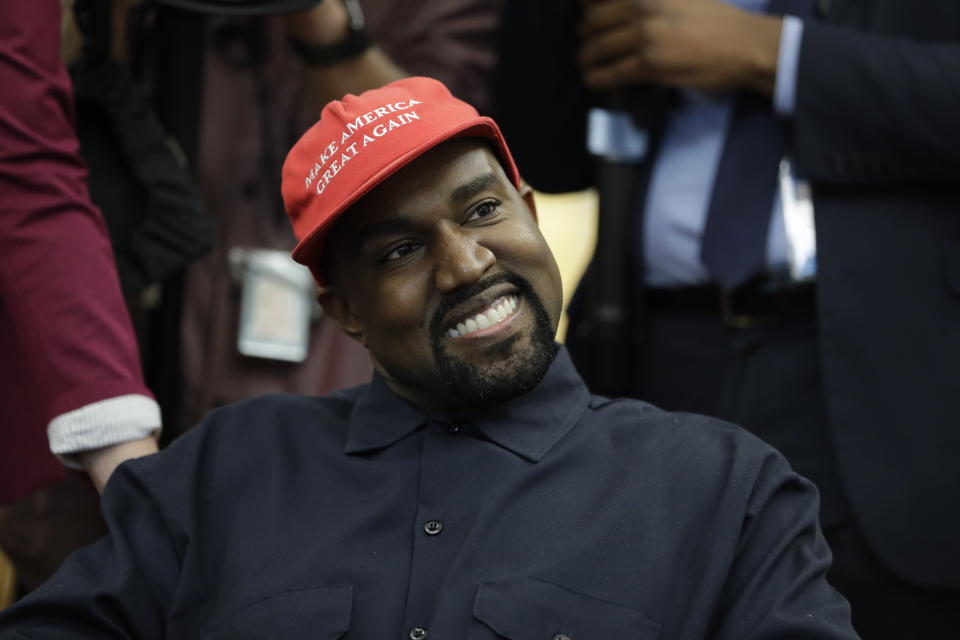 FILE - Rapper Kanye West wears a Make America Great again hat during a meeting with President Donald Trump in the Oval Office of the White House in Washington on Oct. 11, 2018. West says he is no longer a Trump supporter. The rapper, who once praised Trump, tells Forbes in a story published Wednesday that he is “taking the red hat off” — a reference to Trump’s trademark red “Make America Great Again” cap. West also insisted that his weekend announcement that he’s running for President was not a stunt to drum up interest in an upcoming album. (AP Photo/Evan Vucci, File)