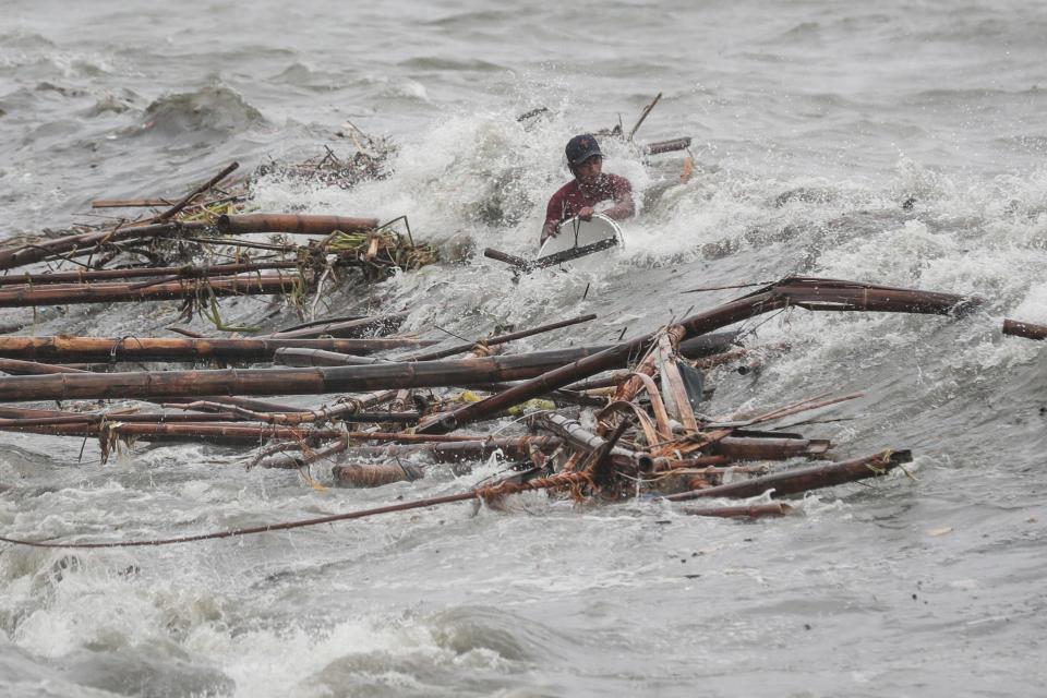 <p>A man is hit by a wave while attempting to recover salvageable materials in Manila Bay, Manila, Philippines, on Sept. 15, 2018.<br>Mangkhut, the most powerful typhoon to strike the Philippines in the last five years, made landfall in the northeastern town of Baggao with maximum sustained winds of 205 km/h (128 mph) and gusts of up to 285 km/h (177 mph). The Category 5 storm came ashore at 1:40 am (17:40 GMT on 14 September) in Cagayan province, the Philippine Atmospheric, Geophysical, and Astronomical Services Administration (PAGASA) said. Mangkhut, denoted Ompong in the Philippines, is moving west-northwest at 35 km/h and is expected to exit the archipelago in the direction of Hong Kong late 15 September, according to the PAGASA bulletin. Forecasters said that coastal areas in the impact zone could experience a storm surge of as much as 6 metres.<br>(Photo by Mark R. Cristino, EPA) </p>