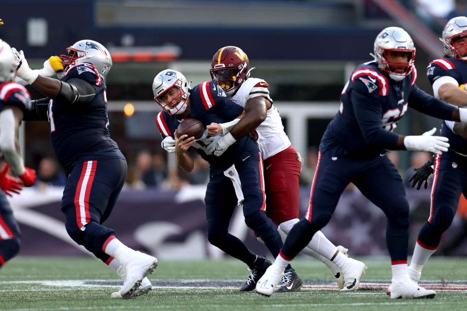 FOXBOROUGH, MASSACHUSETTS - NOVEMBER 05: KJ Henry #55 of the Washington Commanders sacks Mac Jones #10 of the New England Patriots during the second half at Gillette Stadium on November 05, 2023 in Foxborough, Massachusetts. (Photo by Maddie Meyer/Getty Images)