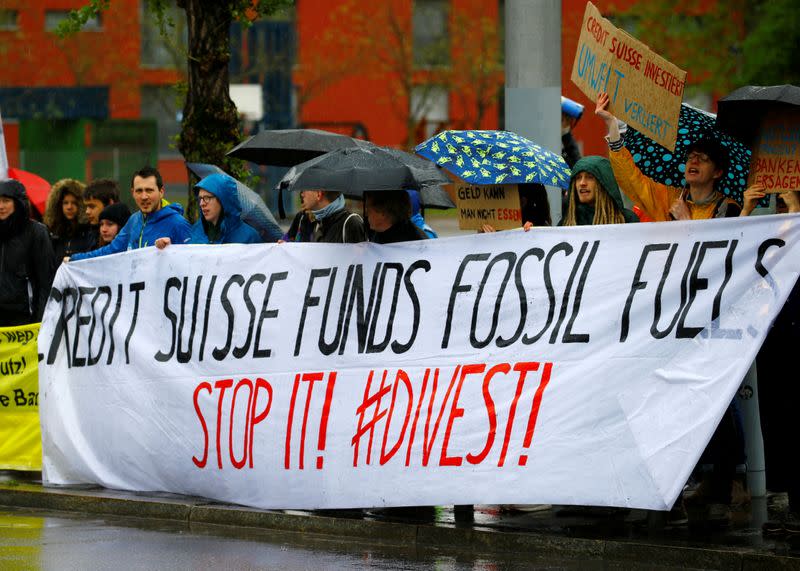 FILE PHOTO: Climate protestors display a banner outside the venue where Swiss bank Credit Suisse holds the company's annual shareholder meeting in Zurich