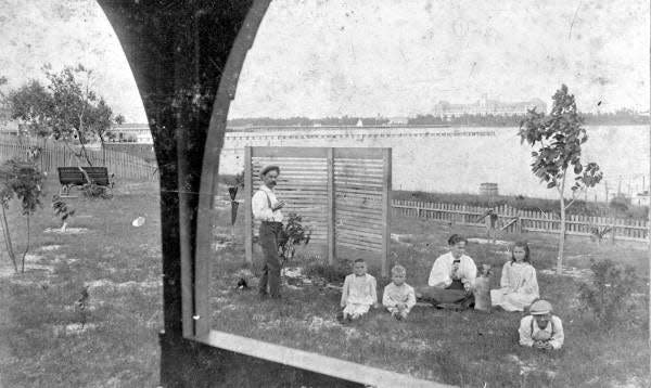 Louis Burkhardt and his family at the site of his lakefront home at the foot of Fern Street in West Palm Beach.