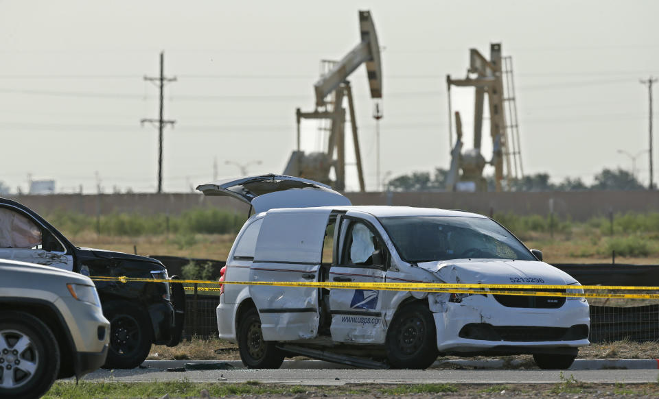 FILE - In this Sept. 1, 2019, file photo, a U.S. Mail vehicle, right, which was involved in Saturday's shooting, sits outside the Cinergy entertainment center in Odessa, Texas. The mass shooting in West Texas spread terror over more than 10 miles (16 kilometers) as the gunman, Seth Aaron Ator, fired from behind the wheel of a car. Ator zigzagged through Midland and Odessa, two closely intertwined cities now brought closer by tragedy. (AP Photo/Sue Ogrocki, File)