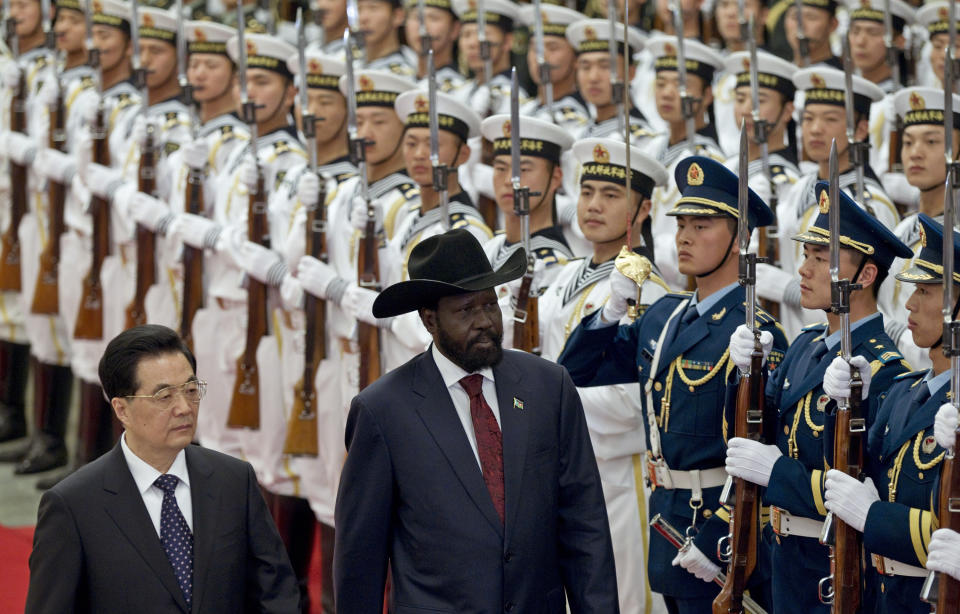 South Sudan's President Salva Kiir, right, reviews honor guard with Chinese President Hu Jintao, left, during a welcoming ceremony at the Great Hall of the People in Beijing, China, Tuesday, April 24, 2012. (AP Photo/Alexander F. Yuan)