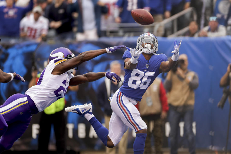 New York Giants wide receiver Darius Slayton (86) makes a touchdown catch against Minnesota Vikings cornerback Xavier Rhodes (29) during the second quarter of an NFL football game, Sunday, Oct. 6, 2019, in East Rutherford, N.J. (AP Photo/Adam Hunger)