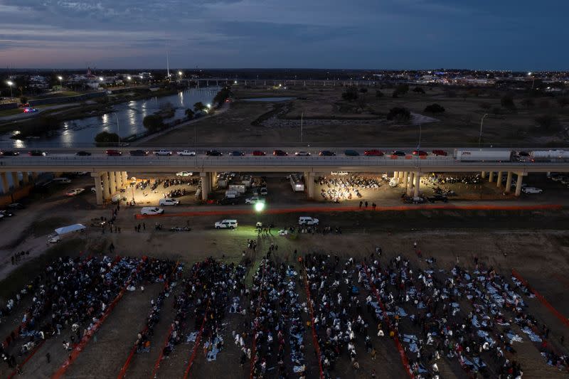 Migrants cross from Mexico into Eagle Pass, Texas