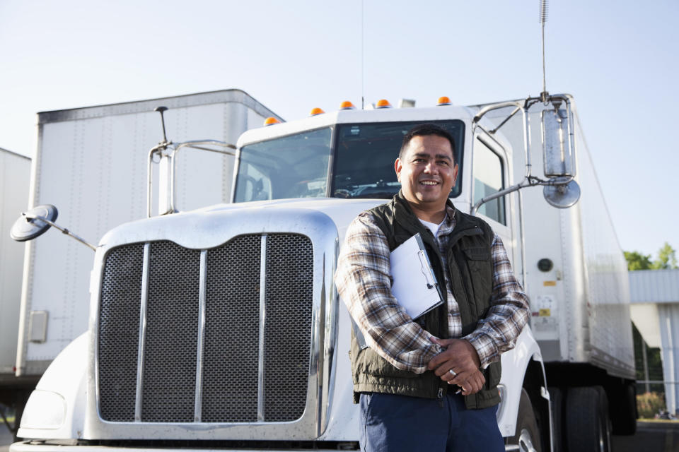 A man standing in front of a truck