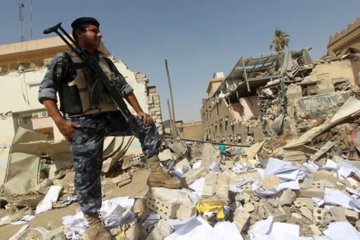 An Iraqi policeman inspects the damage following a bomb attack on the Shiite endowment headquarters in central Baghdad. Iraqi leaders appealed for calm after a suicide bomber killed 25 people at a Shiite foundation's offices in Baghdad, sparking fears of sectarian strife at a time of political crisis