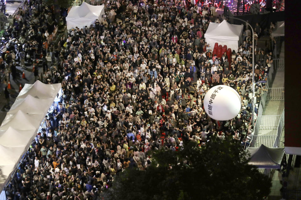 Supporters of the ruling Democratic Progressive Party (DPP) gather and push an ball reading ''Reject China's Interference In Politics'' outside of the legislative building in Taipei, Taiwan, Tuesday, May 28, 2024. (AP Photo/Chiang Ying-ying)