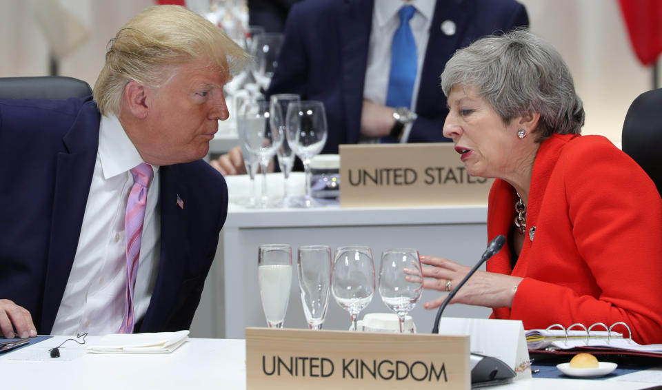 Britain's Prime Minister Theresa May speaks with U.S. President Donald Trump during the G20 summit in Osaka, Japan June 28, 2019. Sputnik/Mikhail Klimentyev/Kremlin 