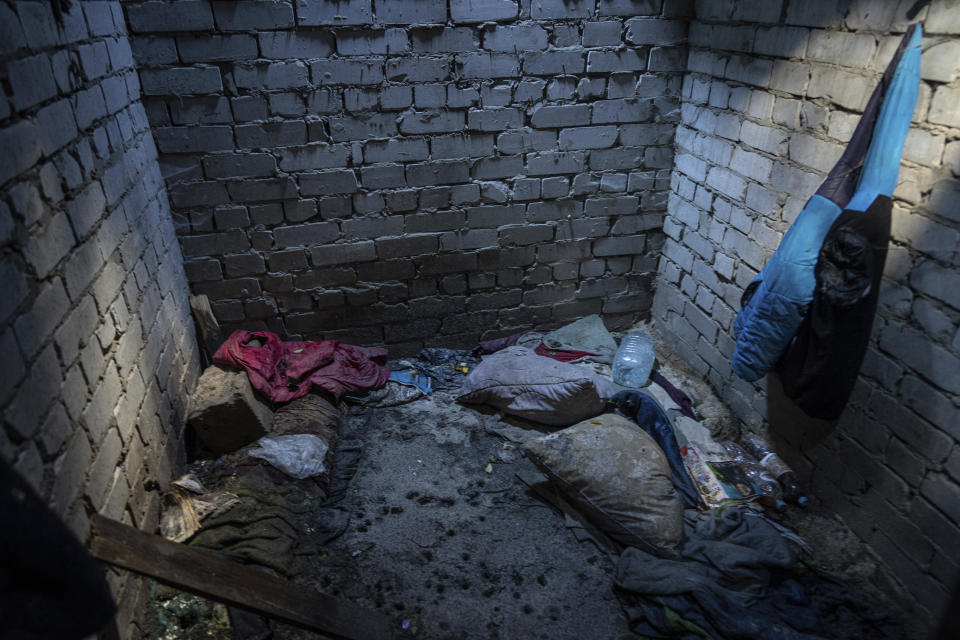 Items left behind sit in the deep sunless pit in a residential compound in the recently liberated town of Izium, Ukraine, Tuesday, Sept. 20, 2022. Based on accounts of survivors and police, Associated Press journalists located 10 torture sites in the town and gained access to five of them including the compound. (AP Photo/Evgeniy Maloletka)