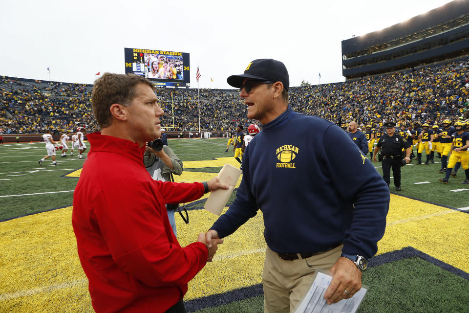 Rutgers head coach Chris Ash, left, and Michigan head coach Jim Harbaugh shake hands after an NCAA college football game in Ann Arbor, Mich., Saturday, Sept. 28, 2019. Michigan won 52-0. (AP Photo/Paul Sancya)