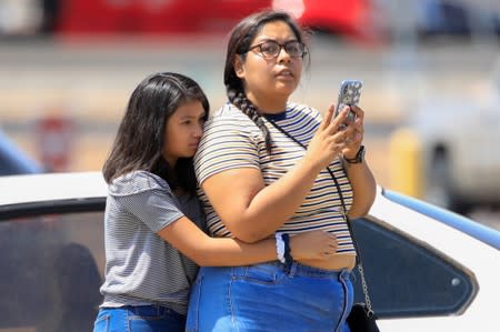 A girl reacts after a mass shooting at a Walmart in El Paso