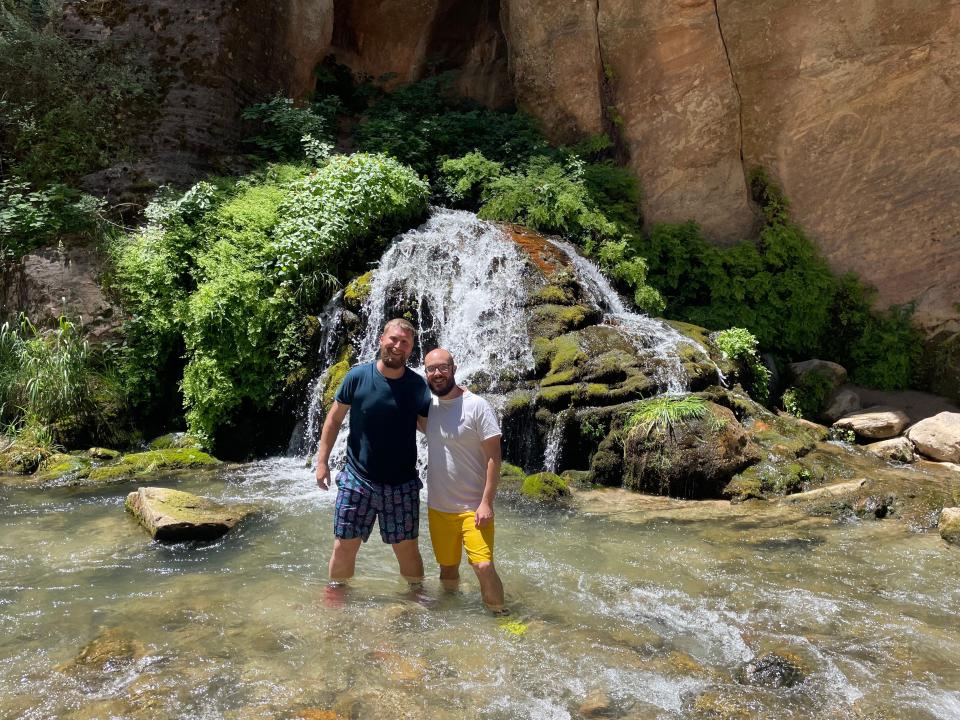 timothy and his husband trent at the narrows in zion national park