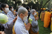 Monks and Thich Nhat Hanh followers pray during the funeral of the Vietnamese Buddhist monk in Hue, Vietnam Saturday, Jan. 29, 2022. A funeral was held Saturday for Thich Nhat Hanh, a week after the renowned Zen master died at the age of 95 in Hue in central Vietnam. (AP Photo/Thanh Vo)