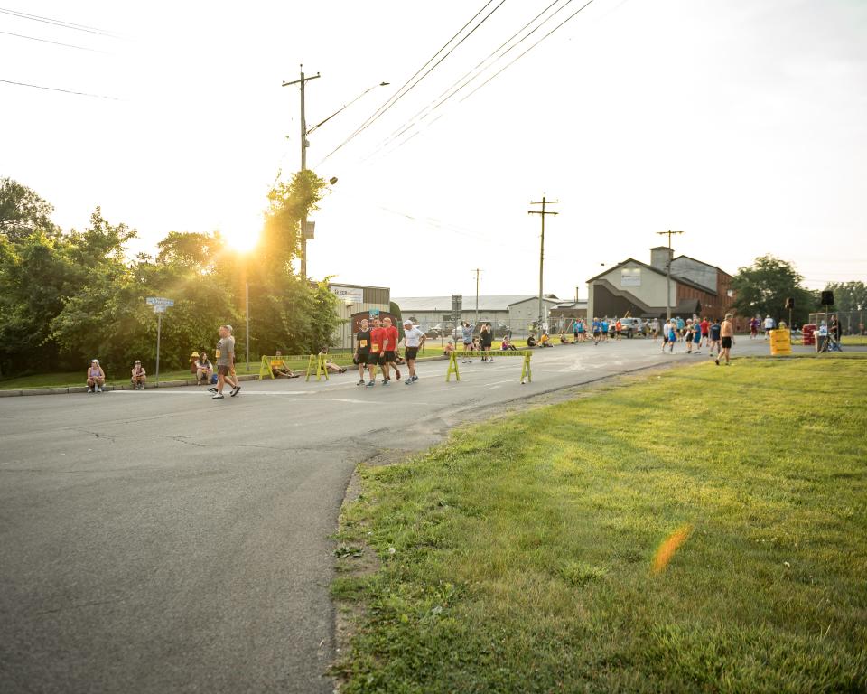 Runners begin to arrive at the Boilermaker starting line early in the morning in Utica, NY on Sunday, July 9, 2023.