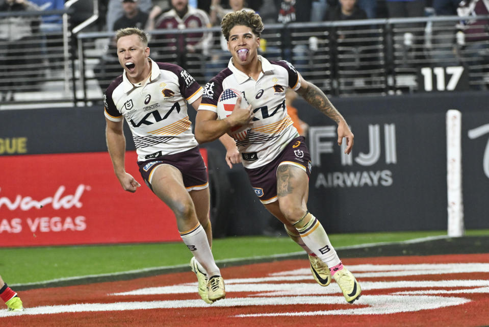 Broncos Reece Walsh reacts as he runs in to score a try during the NRL match between the Sydney Roosters and the Brisbane Broncos at Allegiant Stadium in Las Vegas, Saturday, March 2, 2024. (AP Photo/David Becker)