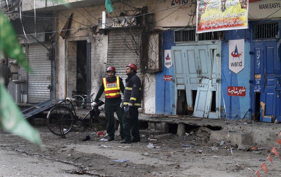 Pakistani rescuers collect remains at the site of a suicide bombing in Rawalpindi, Pakistan,Monday, Jan. 20, 2014. A Taliban suicide bomber blew himself up not far from Pakistan’s military headquarters Monday, killing nine people a day after a militants bombing inside an army compound in the northwest of the country, officials and militants said. (AP Photo/Anjum Naveed)