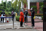 A student wearing a protective face mask and face shield gets her temperature measured as she arrives at an examination centre for Joint Entrance Examination (JEE), amidst the spread of the coronavirus disease (COVID-19), in Kolkata, India, September 1, 2020. REUTERS/Rupak De Chowdhuri