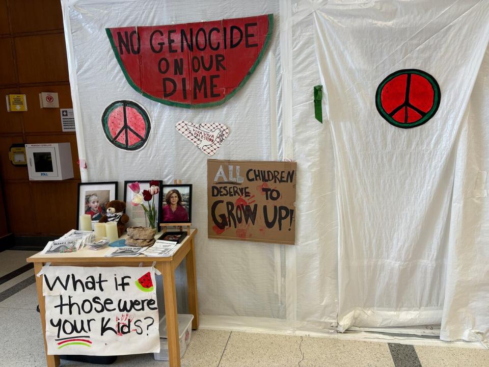 Protestors have erected signage in the Arts and Administration building lobby.