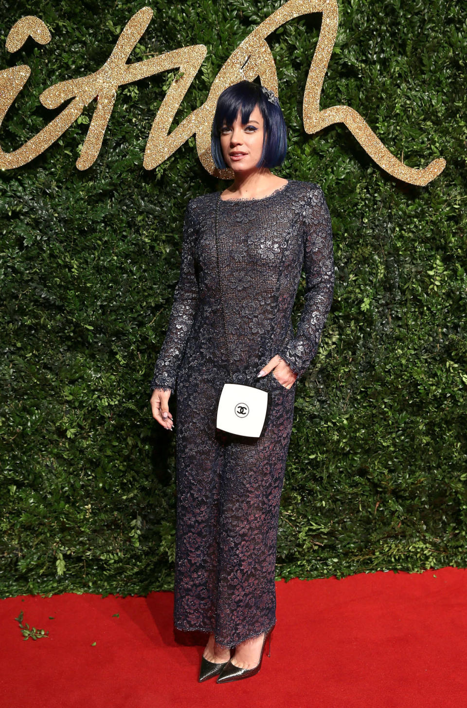 Lily Allen in a gunmetal lace dress and white Chanel purse. 