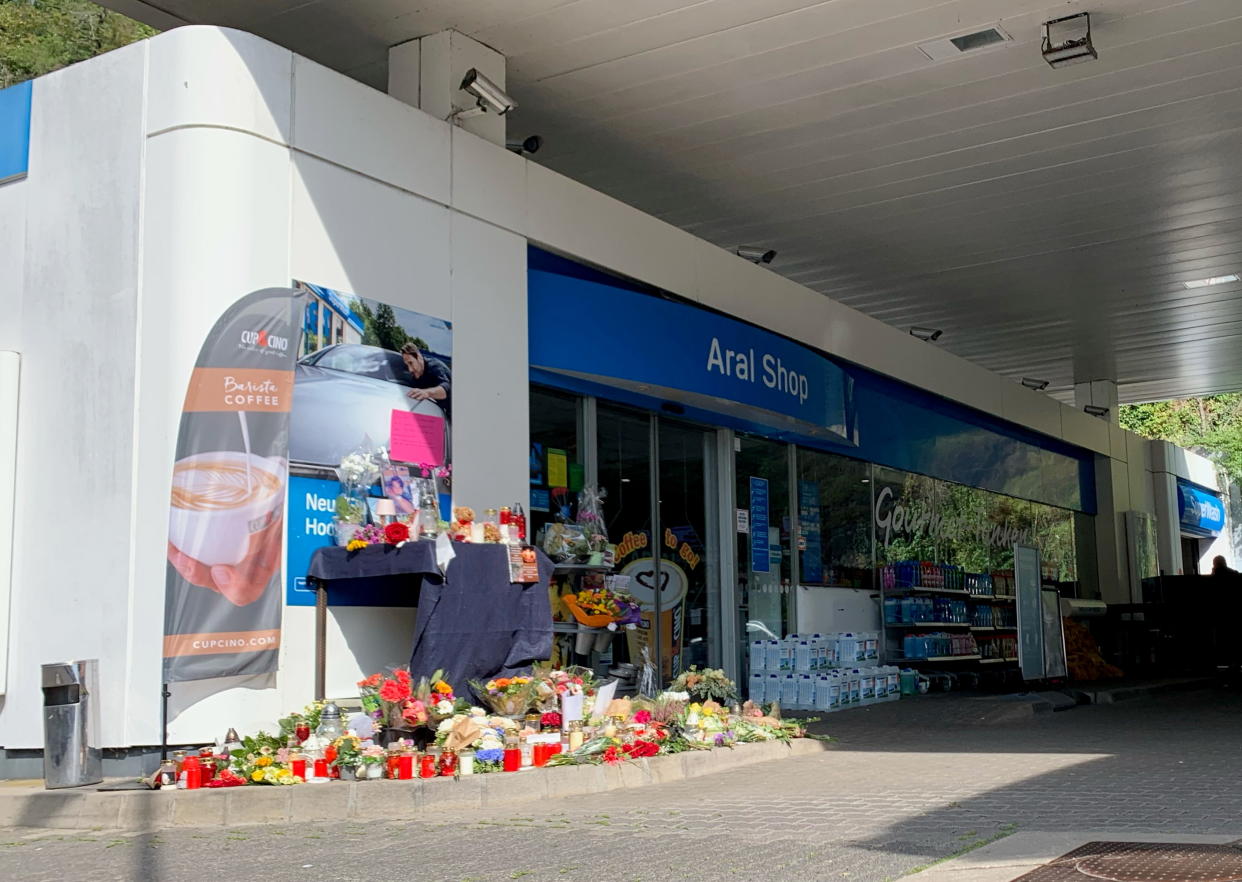 Flowers are placed in front of a gas station in Idar-Oberstein, Germany, September 21, 2021, after a 20-year-old gas station attendant who asked a customer to wear a face mask was shot dead on Saturday.