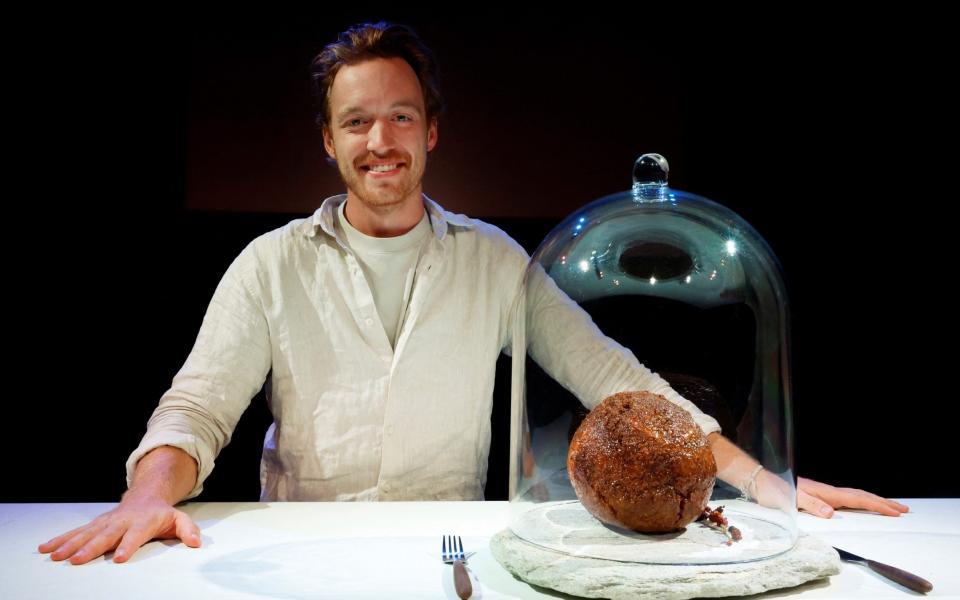 Founder of Australian cultured meat company Vow, Tim Noakesmith shows a meatball - PIROSCHKA VAN DE WOUW