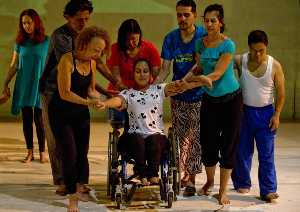 In this Dec. 4, 2018 photo, dancers practice prior to their last performance in the contemporary dance production Ubuntu, at the Teresa Carreno Theater in Caracas, Venezuela. During the show, disabled dancers perform alongside fully abled professional dancers to demonstrate that art knows no barriers. (AP Photo/Fernando Llano)