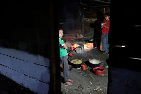 FILE PHOTO: A child looks on from inside his house in the village where Jakelin, a 7-year-old girl who died in U.S. custody, used to live in San Antonio Secortez, municipality of Raxruha, Guatemala December 19, 2018. REUTERS/Luis Echeverria/File Photo