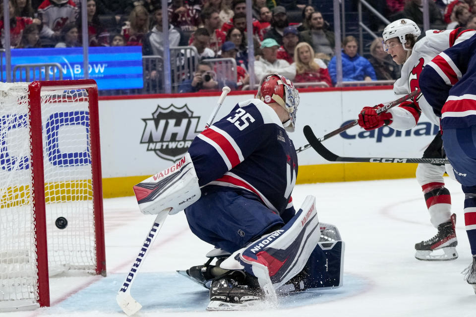 New Jersey Devils center Dawson Mercer, right, scores a goal past Washington Capitals goaltender Darcy Kuemper (35) in the second period of an NHL hockey game, Thursday, March 9, 2023, in Washington. (AP Photo/Alex Brandon)