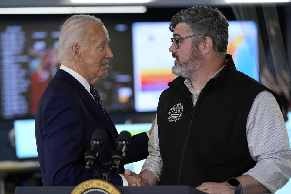 President Joe Biden greets Clint Osborn, acting director of the D.C. Homeland Security and Emergency Management Agency, after he spoke during a visit to the D.C. Emergency Operations Center, Tuesday, July 2, 2024, in Washington. (AP Photo/Evan Vucci)