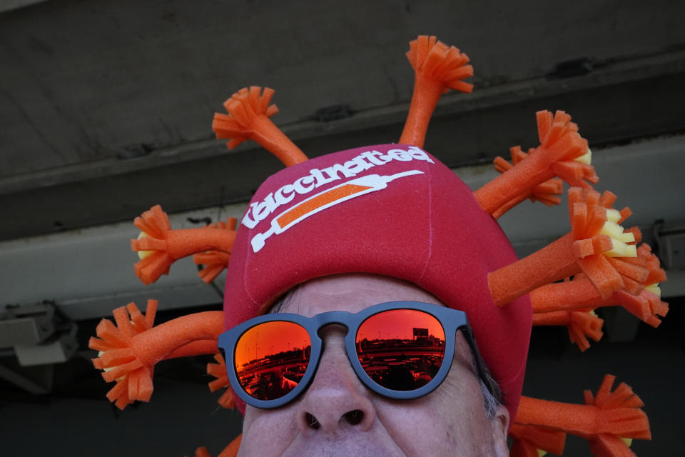 Mark Ferguson wears a coronavirus-themed hat before the 147th running of the Kentucky Derby at Churchill Downs, Saturday, May 1, 2021, in Louisville, Ky. (AP Photo/Brynn Anderson)