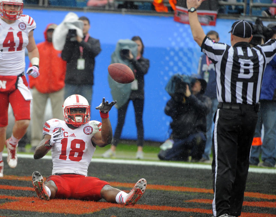 Nebraska wide receiver Quincy Enunwa (18) tossed the ball to an official after scoring a touchdown during the first half of the Gator Bowl NCAA college football game against Georgia, Wednesday, Jan. 1, 2014, in Jacksonville, Fla. (AP Photo/Stephen B. Morton)