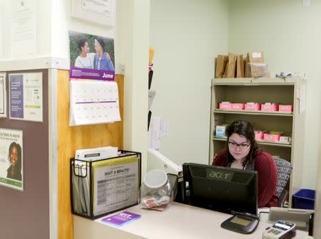 Susana Contreras, 24, a Health Center Assistant for Family Planning at Planned Parenthood South Austin, works at the clinic in Austin, Texas, U.S. June 27, 2016. REUTERS/Ilana Panich-Linsman