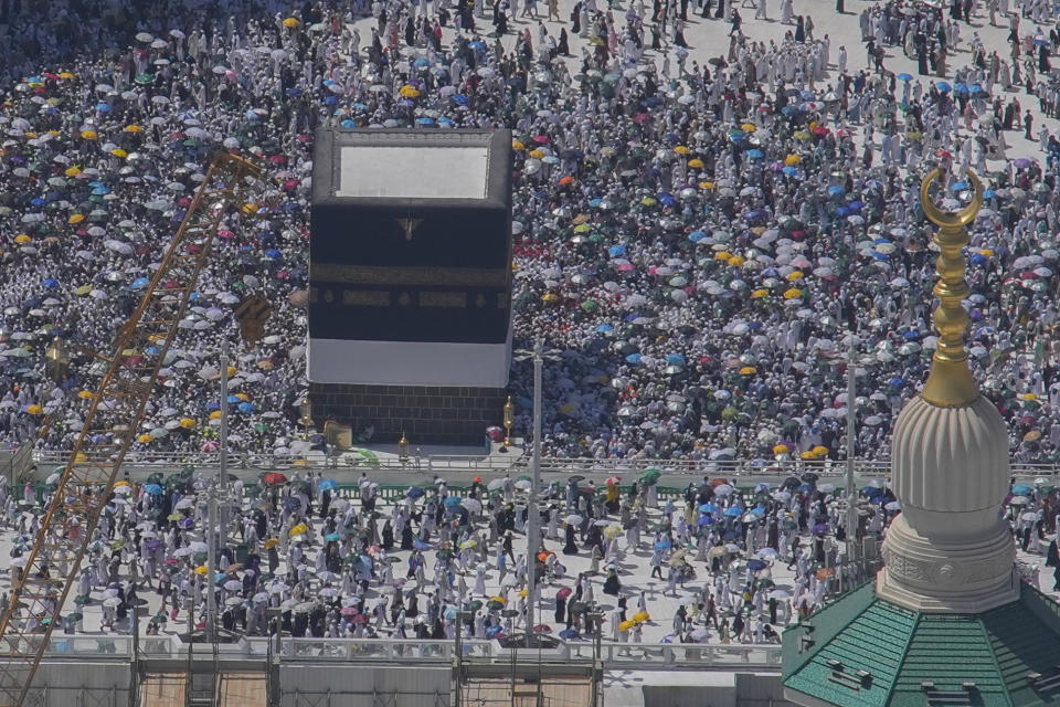 Muslim pilgrims circumambulate the Kaaba, the cubic building at the Grand Mosque, during the annual Hajj pilgrimage in Mecca, Saudi Arabia, Monday, June 17, 2024. Muslim pilgrims used the early morning hours Monday to perform the second day of the symbolic stoning of the devil, as noontime summer heat caused heatstroke among thousands wrapping up the Hajj pilgrimage. (AP Photo/Rafiq Maqbool)