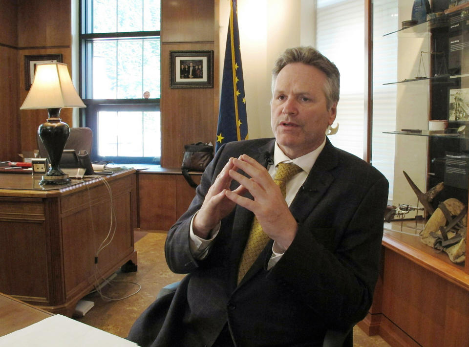 FILE - In this May 29, 2019 file photo, Alaska Gov. Mike Dunleavy speaks to reporters in his office at the state Capitol in Juneau, Alaska. Dunleavy said he hopes to move past the rancor of his first year in office, amid an unsettled dispute with lawmakers over state spending and threat of a recall effort looming large. The Republican will mark a full year in office Tuesday, Dec. 3. (AP Photo/Becky Bohrer, File)