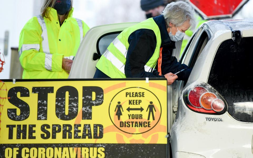 A member of staff administers a COVID-19 vaccine to a member of the public in a drive-thru vaccination centre in Scotland - Jeff J Mitchell/Getty Images Europe