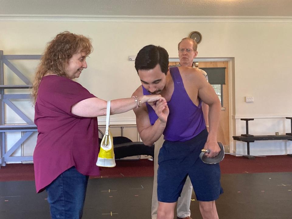 Alex Gossard, portraying Gomez, kisses the hand of Kathleen Keenan, cast as Alice, during rehearsals July 20, 2023 on the campus of the Vermont College of Fine Arts for the Lost Nation Theater production of "The Addams Family" musical.