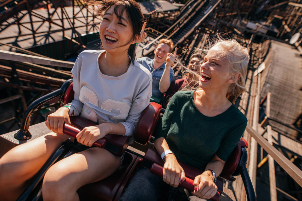 Four young people on a roller coaster