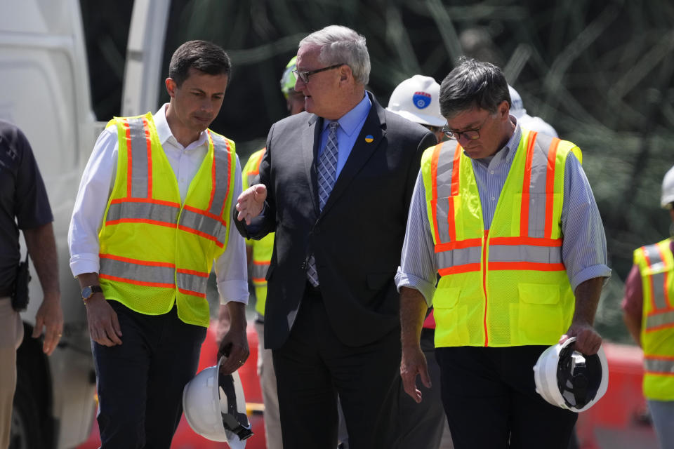 Transportation Secretary Pete Buttigieg, left, meets with Philadelphia Mayor Jim Kenney at the scene of a collapsed elevated section of Interstate 95, in Philadelphia, Tuesday, June 13, 2023. (AP Photo/Matt Slocum)