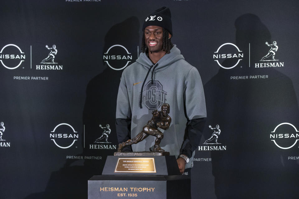 Heisman trophy finalist Ohio State wide receiver Marvin Harrison Jr. poses for a photo with the Heisman Trophy poses for a photo with the Heisman Trophy, Friday, Dec. 8, 2023, in New York. The Heisman Trophy, award to college football's top player, will be announced Saturday, Dec. 9. (AP Photo/Eduardo Munoz Alvarez)