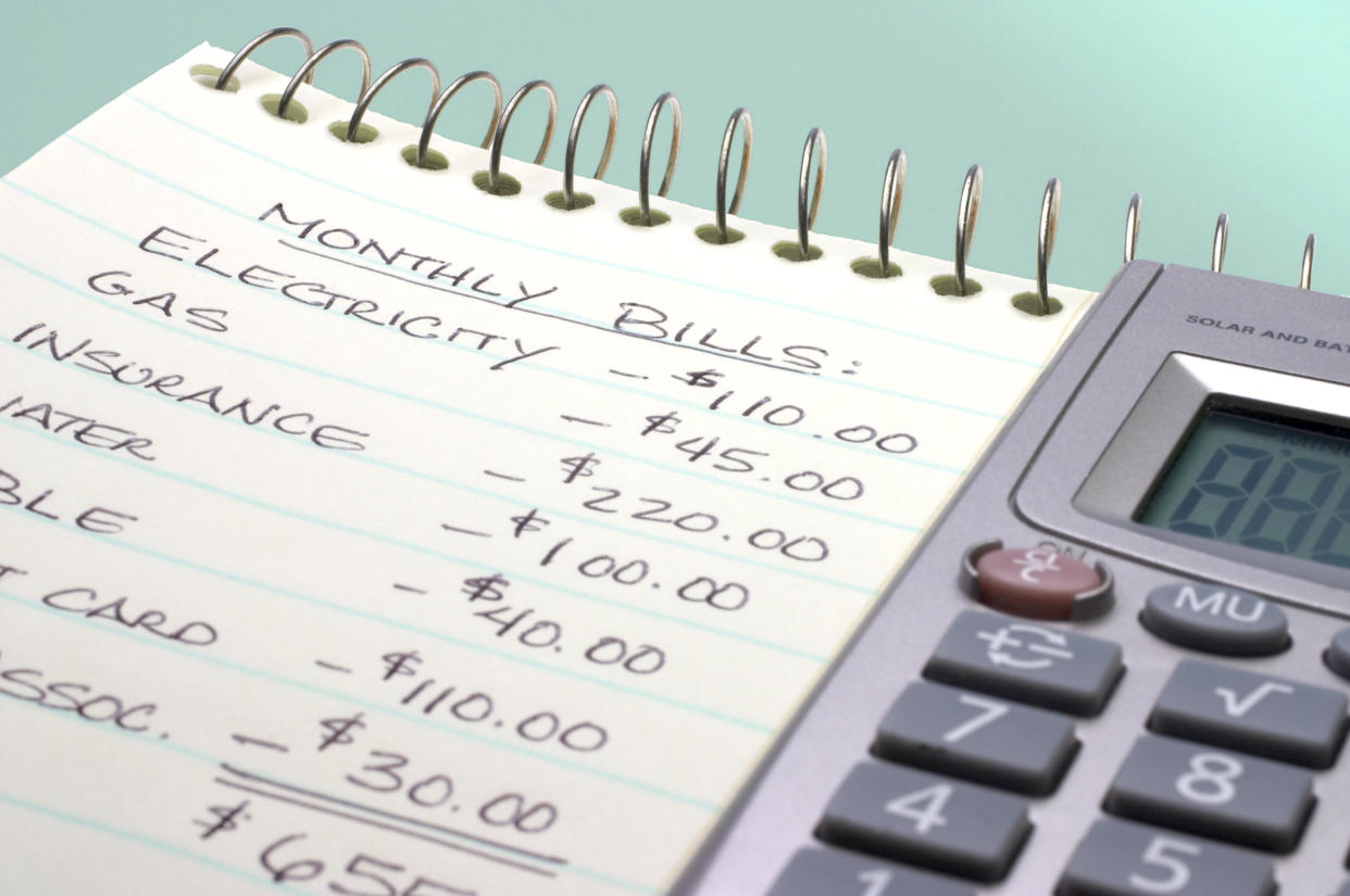 Adding up the monthly bills (Photo: tacojim via Getty Images)