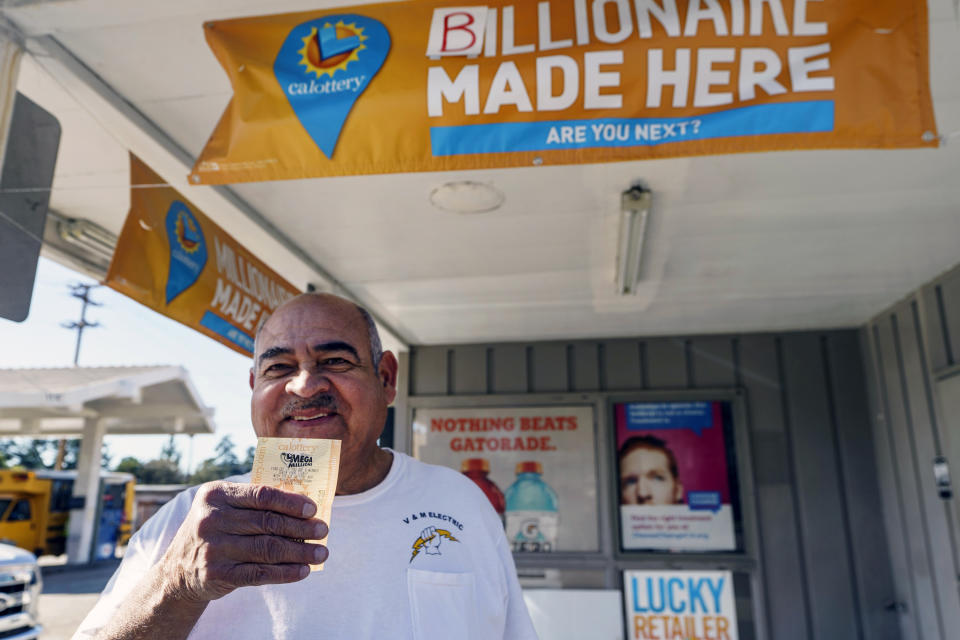 Electrician Jose Valles, 59, from Rancho Cucamonga, Calif., buys a SuperLotto Plus ticket at the gas station that previously sold the $2.04 billion-winning Powerball ticket award at Joe's Service Center, a Mobil gas station at Woodbury Road and Fair Oaks Avenue in Altadena, Calif., Friday, Jan. 6, 2023. Lottery players whose numbers didn't hit or who forgot to even buy a ticket will have another shot at a nearly $1 billion Mega Millions prize. The estimated $940 million jackpot up for grabs Friday night has been growing for more than two months and now ranks as the sixth-largest in U.S history. (AP Photo/Damian Dovarganes)