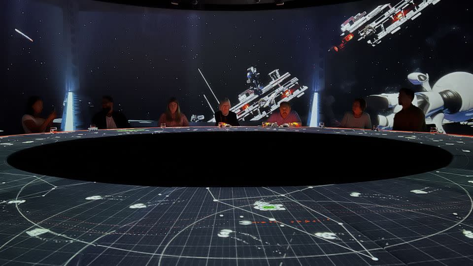 Some courses have interactive gaming elements — such as the space scenarios, where AI-enabled projectors track diners' hands on the table while they "shoot" passing spaceships. - Rebecca Cairns/CNN