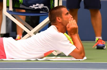 Sept 2, 2016; New York, NY, USA; Mikhail Youzhny of Russia gets treatment on court while playing Novak Djokovic of Serbia on day five of the 2016 U.S. Open tennis tournament at USTA Billie Jean King National Tennis Center. Robert Deutsch-USA TODAY Sports