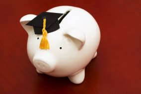 piggy bank with graduation cap  ...