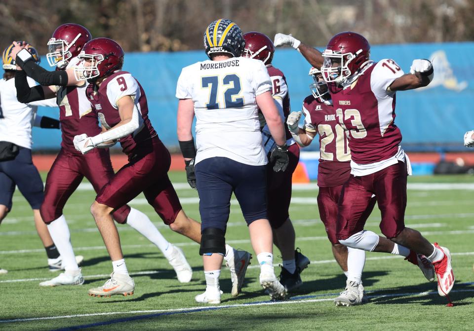 O'Neill players celebrate a first-half fumble recovery against Warrensburg during the Class C football state semifinal at Middletown High School Nov. 26, 2022.